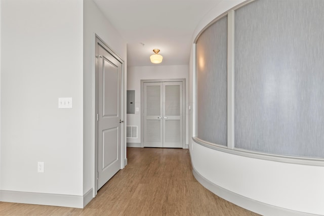 hallway with hardwood / wood-style floors