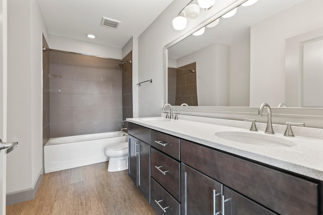51 N High St Unit 506, Columbus, OH 43215 - bathroom featuring double vanity, washtub / shower combination, wood finished floors, and recessed lighting