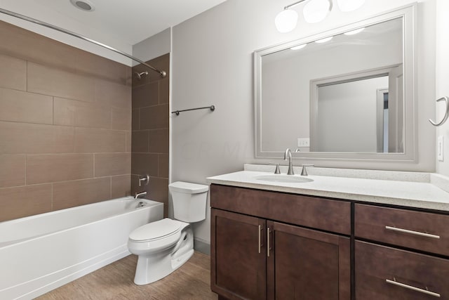 full bathroom featuring toilet, vanity, tiled shower / bath combo, and hardwood / wood-style flooring