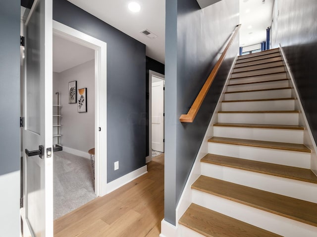 stairs with wood-type flooring