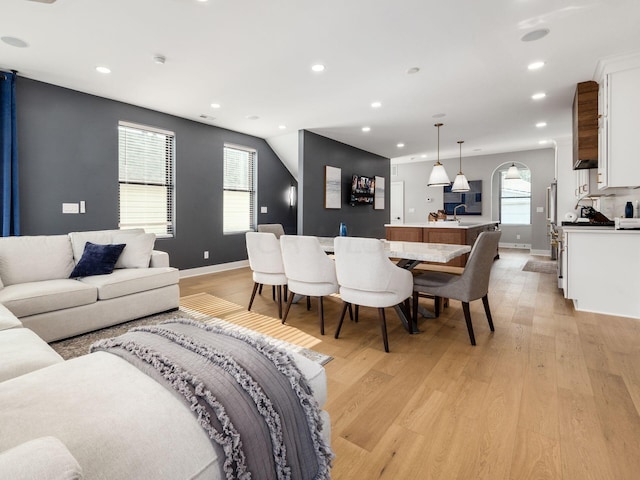 living room featuring plenty of natural light and light hardwood / wood-style flooring