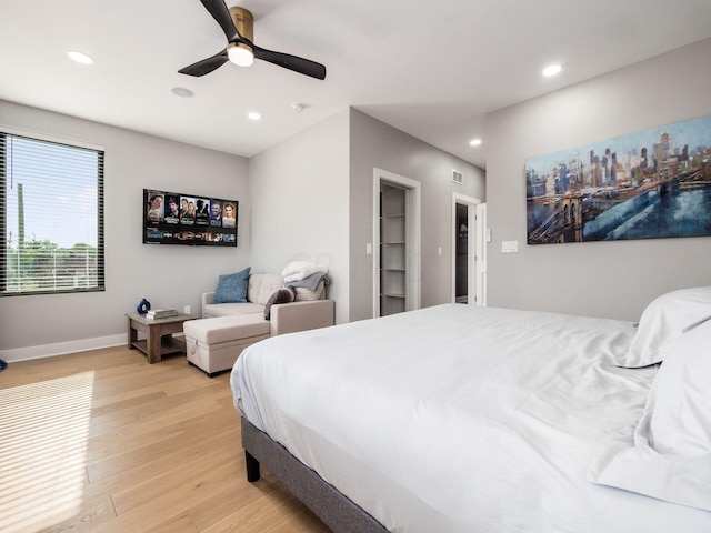 bedroom with light hardwood / wood-style flooring and ceiling fan