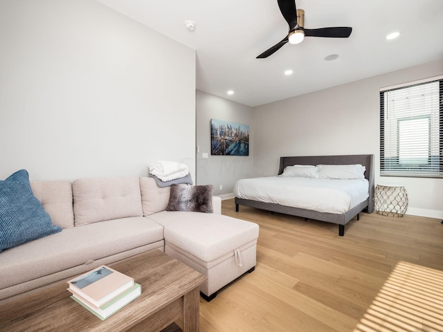 bedroom with ceiling fan and light hardwood / wood-style floors