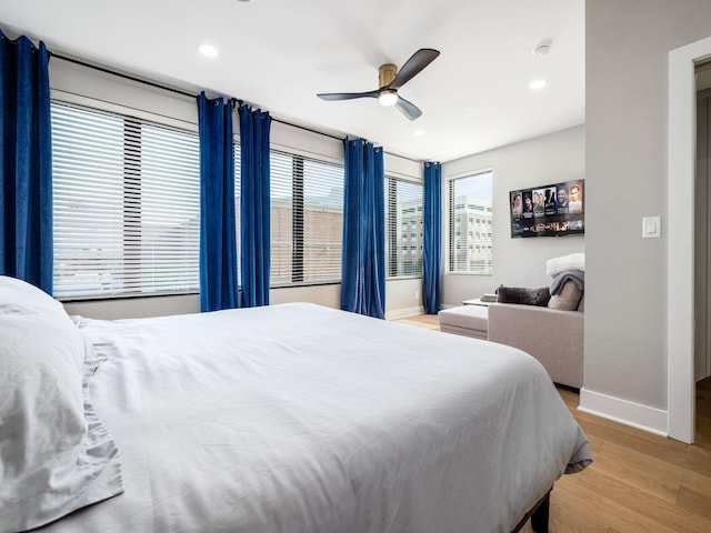 bedroom with ceiling fan and light hardwood / wood-style floors