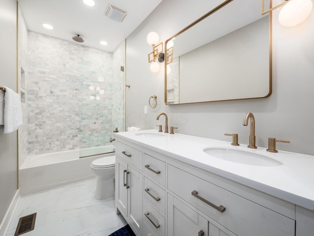 full bathroom with vanity, toilet, and tiled shower / bath