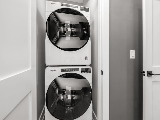 laundry area featuring stacked washer / dryer