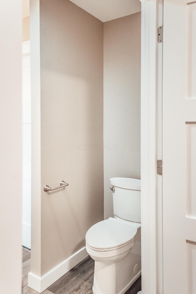 bathroom featuring hardwood / wood-style floors and toilet