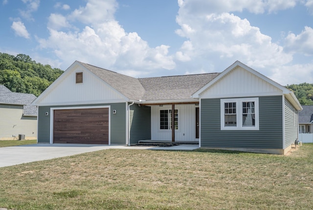 view of front facade with a garage, covered porch, and a front yard