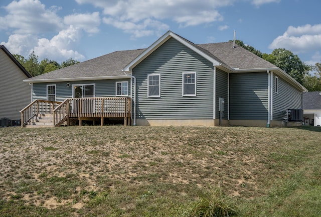 rear view of house featuring a yard and a deck