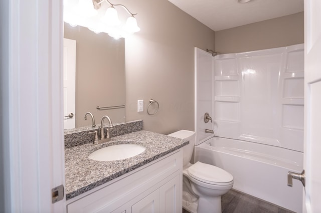 full bathroom with hardwood / wood-style floors, vanity, bathtub / shower combination, and toilet