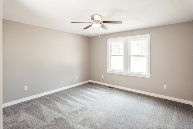 carpeted spare room with ceiling fan