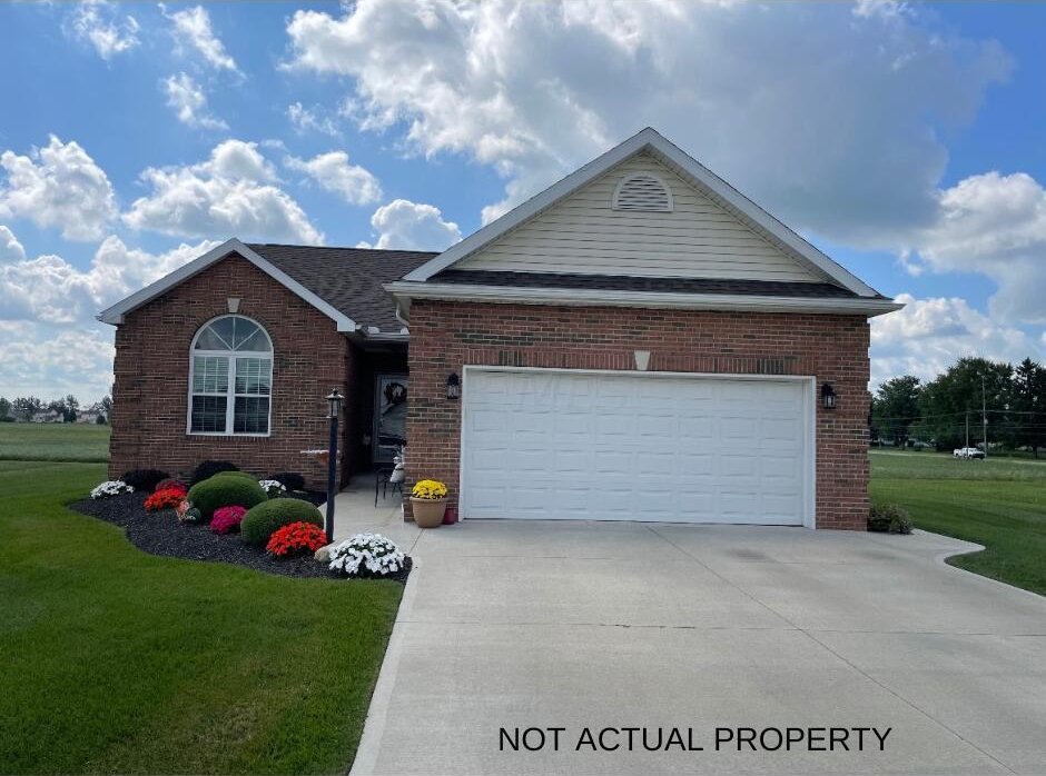 single story home featuring a garage and a front lawn