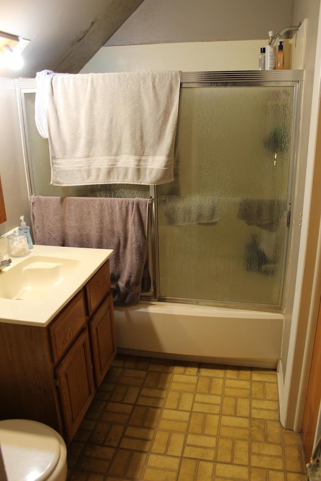 full bathroom featuring vanity, toilet, and bath / shower combo with glass door