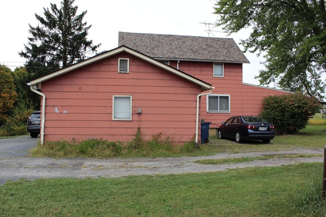 view of side of home featuring a lawn