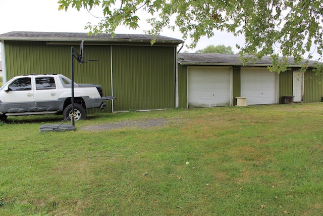 exterior space with a garage and a yard