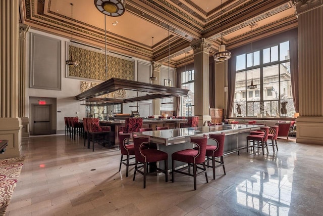 51 N High St Unit 307, Columbus, OH 43215 - dining space featuring decorative columns, a towering ceiling, and ornamental molding