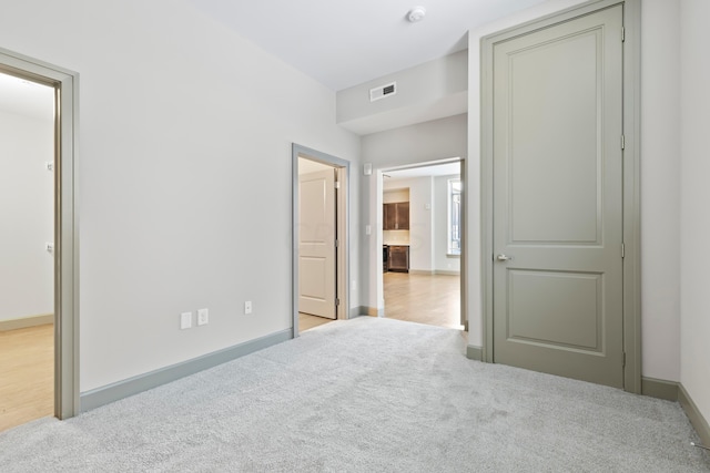 bedroom featuring light colored carpet