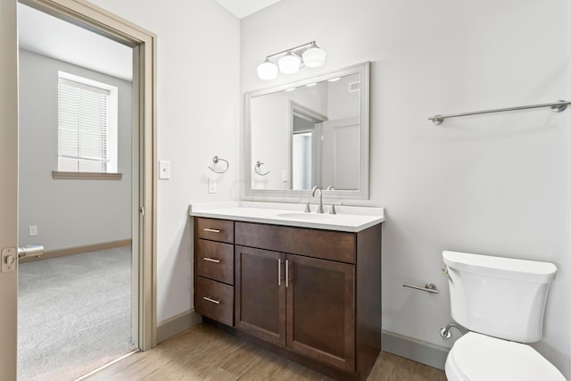 bathroom featuring hardwood / wood-style floors, vanity, and toilet