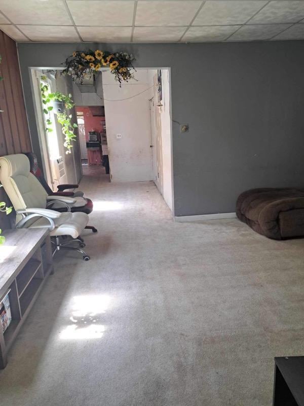 unfurnished room featuring carpet floors and a paneled ceiling