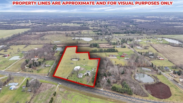 birds eye view of property featuring a rural view and a water view