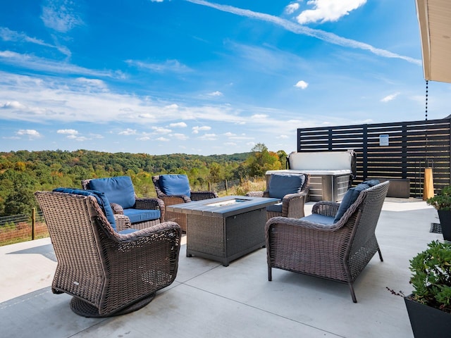 view of patio / terrace with an outdoor living space with a fire pit