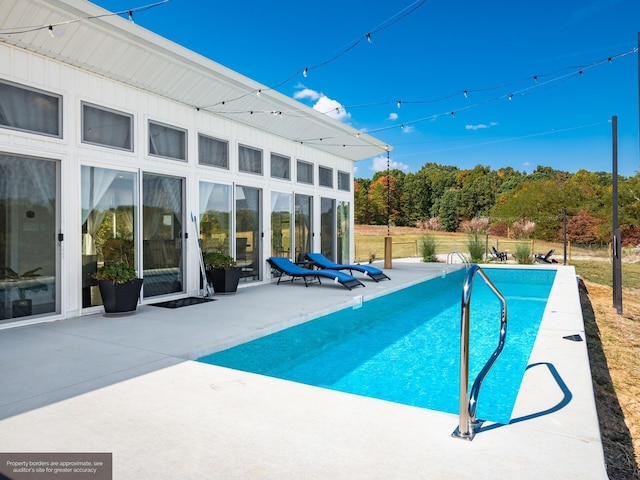 view of swimming pool featuring a patio area