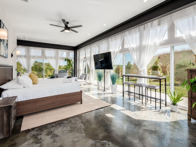 bedroom featuring concrete flooring, multiple windows, and ceiling fan