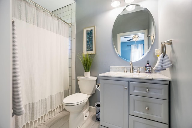 bathroom featuring ceiling fan, vanity, and toilet