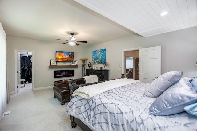 bedroom featuring ceiling fan, light colored carpet, a spacious closet, and a closet