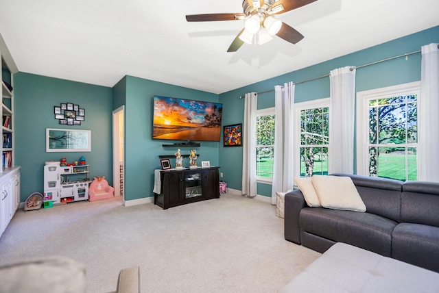 carpeted living room featuring ceiling fan