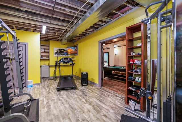 exercise area featuring light wood-type flooring and pool table