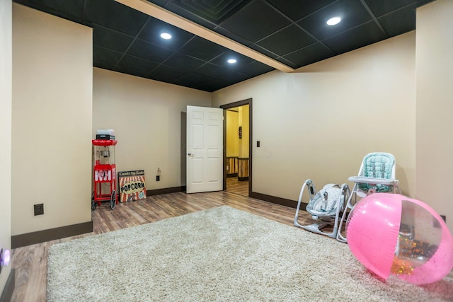 rec room featuring hardwood / wood-style floors and a drop ceiling