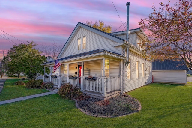 view of front of property with a yard and covered porch