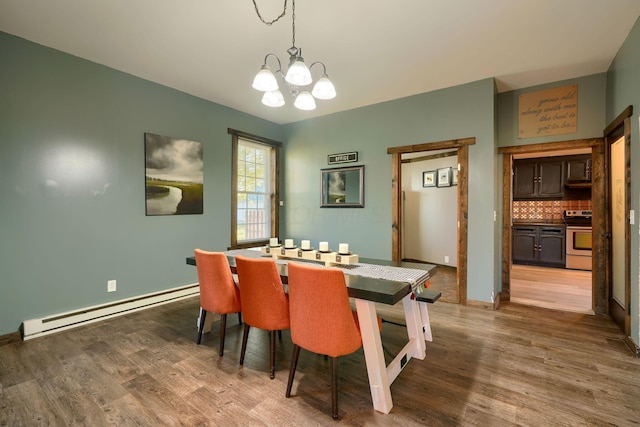 dining room with a chandelier, hardwood / wood-style floors, and a baseboard radiator