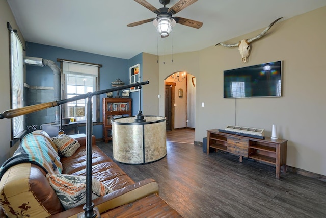 living room featuring ceiling fan and dark wood-type flooring