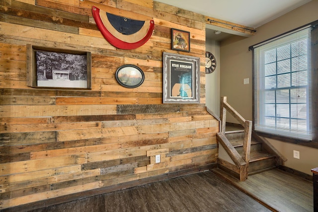 interior details featuring wood walls and hardwood / wood-style flooring