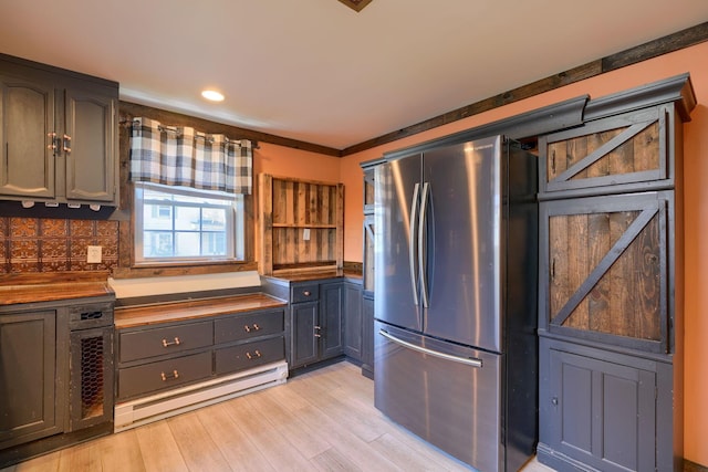 kitchen with decorative backsplash, stainless steel fridge, light hardwood / wood-style floors, and ornamental molding