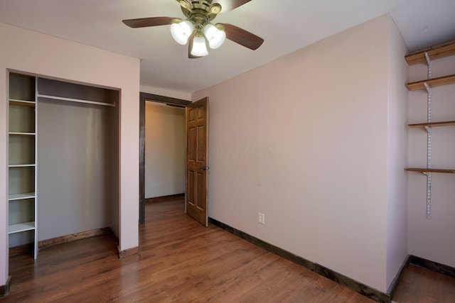 unfurnished bedroom with a closet, ceiling fan, and dark hardwood / wood-style flooring