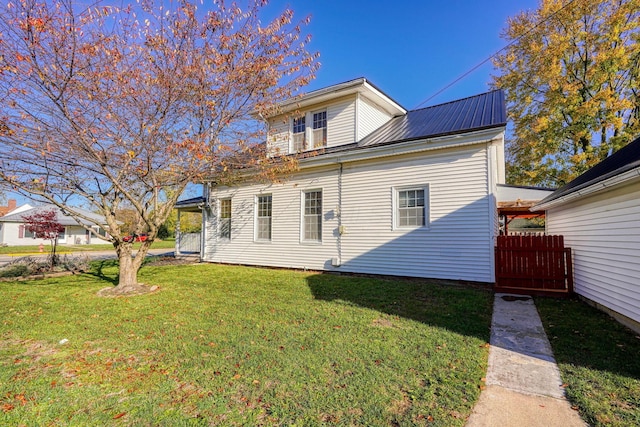 back of house with a lawn