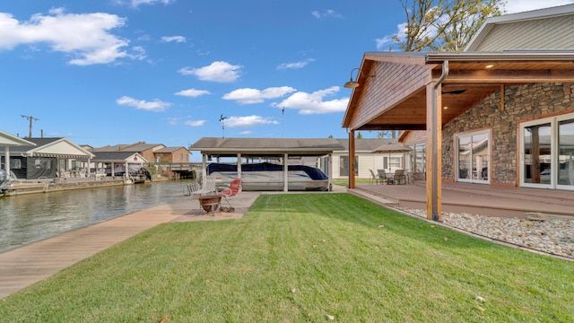 view of yard featuring a dock and a water view