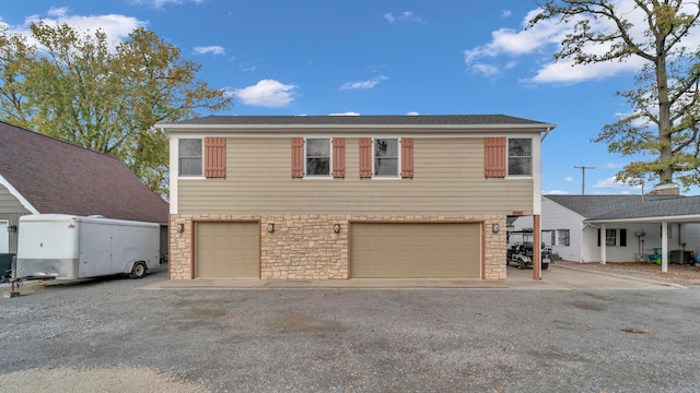 view of front of house with cooling unit and a garage