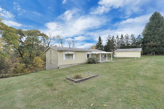 rear view of house featuring a yard