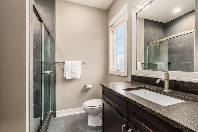 full bath featuring toilet, tile patterned floors, baseboards, and a shower stall