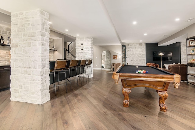 game room featuring arched walkways, wood finished floors, pool table, and recessed lighting
