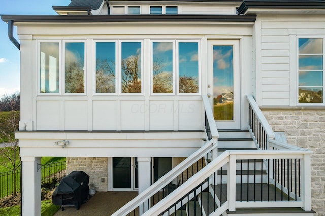 entrance to property with stone siding