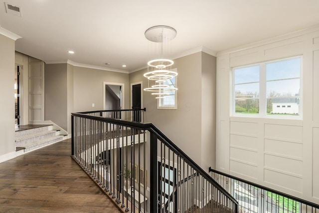 staircase featuring ornamental molding, a chandelier, recessed lighting, visible vents, and wood finished floors