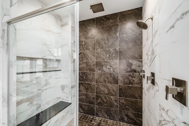 bathroom with a marble finish shower