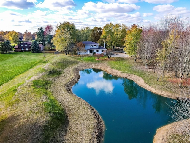 view of swimming pool featuring a water view and a yard