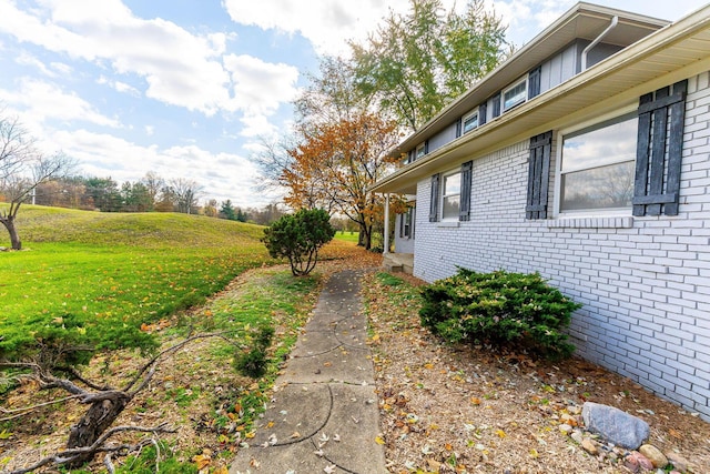 view of home's exterior with a yard