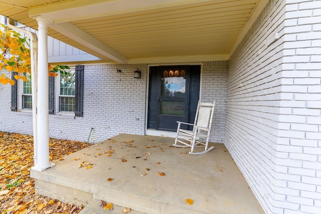 view of exterior entry featuring a porch